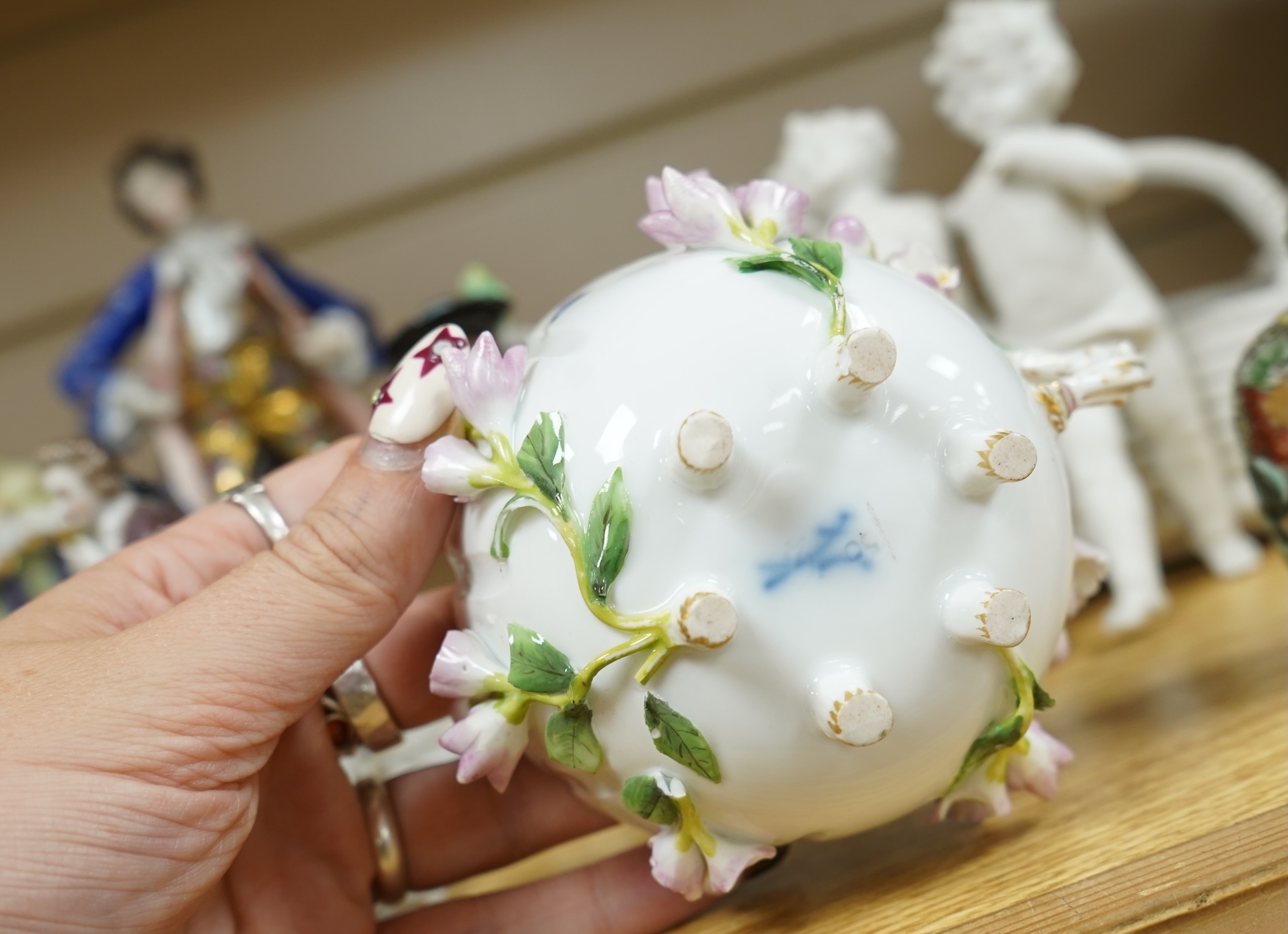 A French porcelain figure of a Mansion House dwarf, various German porcelain figures, an engraved glass and bowl. Glass 19cm
